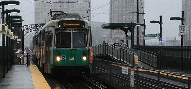 Image of a platform for a commuter train on a rainy day in Boston